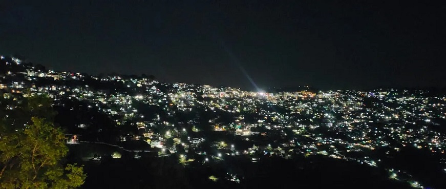 almora glowing with electric lights at night.