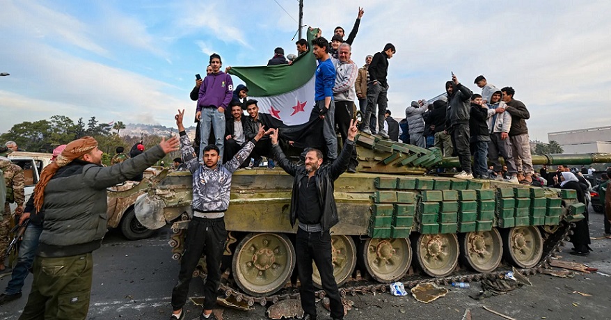 rebel fighters celebrating after capturing syria.